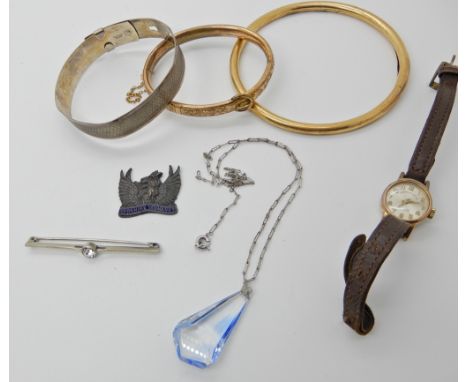 A rolled gold slave bangle, a gold plated buckle shaped bangle and other items Condition Report: Available upon request