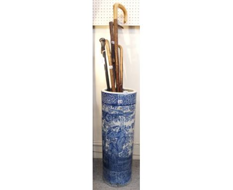 A Chinese blue and white stickstand together with a silver topped walking stick and four other sticks Condition Report: The s