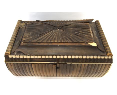 A 19th Century Anglo-Indian horn and ivory sarcophagus shaped tea caddy, 35cm wide, the interior fitted with two compartments