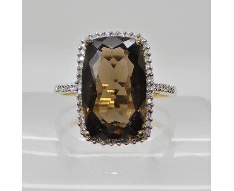 A 9ct gold diamond and smoky quartz ring, by QVC, finger size U1/2, weight 4gms Condition Report: Available upon request