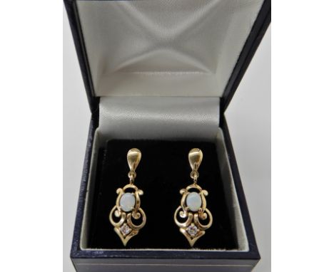 A pair of 9ct gold opal and diamond drop earrings length 2.8cm, weight 2.6gms Condition Report: Light general wear. 