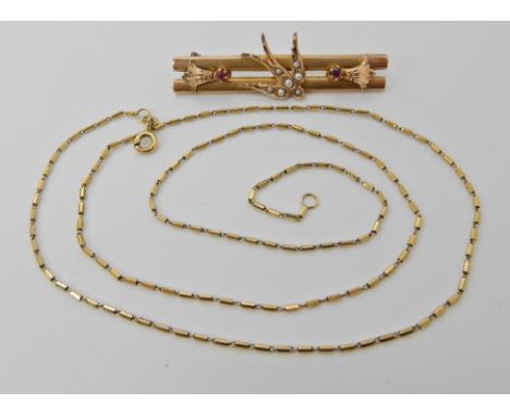 A 9ct gold ruby and pearl set swallow brooch length 4.5cm, together with a 9ct gold decorative chain, clasp (af) combined wei