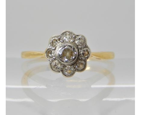 A bright yellow metal diamond flower ring of estimated approx combined 0.25cts, finger size S, weight 2.7gms Condition Report