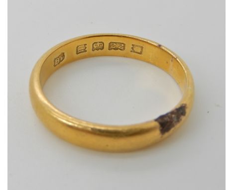 A 22ct gold wedding ring, size R1/2, weight 5.1gms Condition Report: the area of black is an area of burning, I've seen this 