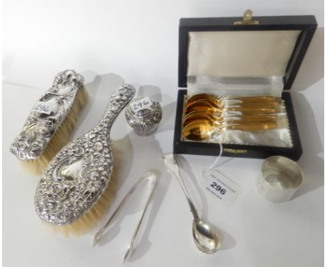 A lot comprising a cased set of six German gilt metal coffee spoons, two silver mounted brushes, a silver napkin ring, a silv