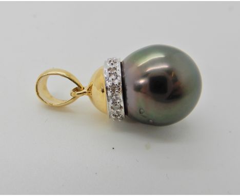 An 18ct gold black pearl and diamond pendant, length 2.1cm, weight 2.4gms Condition Report: Available upon request