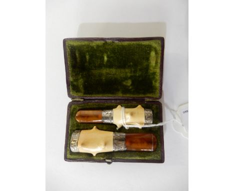 A cased pair of amber and ivory cigar and cigarette holders, each 6.2cm long approx Condition Report: Available upon request