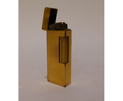 A Dunhill gilt metal cigarette lighter with engine turned body, 6.5cm long Condition Report: Available upon request