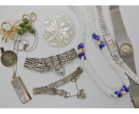 A silver ingot pendant, two silver gate bracelets and other items Condition Report: Available upon request