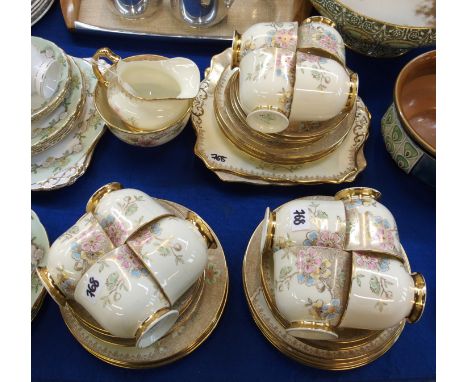 A Plant Tuscan twelve setting teaset, decorated with pink, blue and yellow flowers on an ivory ground, comprising; twelve cup