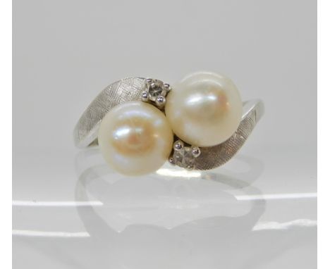 A 14ct white gold pearl and diamond ring size Q1/2, weight 3.1gms Condition Report: Mount and diamonds ok, pearls have a litt