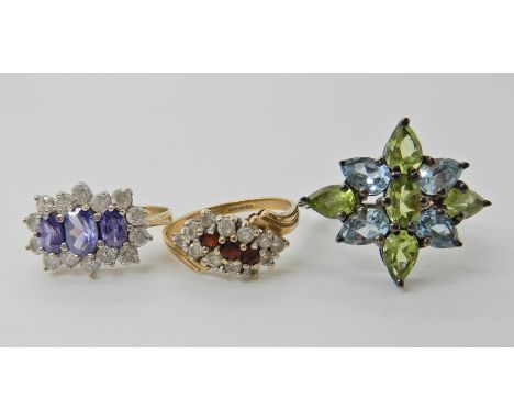 A 9ct tanzanite and clear gem cluster ring, size M, a 9ct gold red and clear gem ring size O, weight for both rings together 