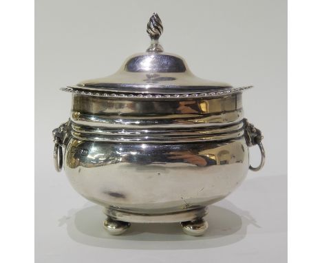 A silver tea caddy with lion mask handles by George Nathan &amp; Ridley Hayes, Chester 1915, 10cm high x 11cm long, 187gms Co