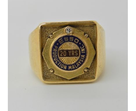 An 18ct gold gents ring to celebrate 20 years of ESSO in Malaysia, set with a diamond and enamel, size V1/2 approx, weight 17