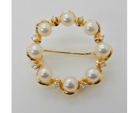 An 18ct gold Mikimoto diamond and pearl brooch diameter 2.5cm, weight 4.3gms, in original box Condition Report: Available upo