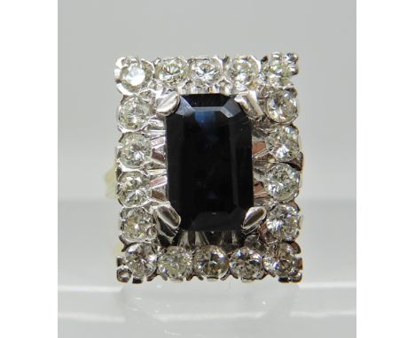 An 18ct gold sapphire and diamond oblong cluster ring, sapphire approx 10.5mm x 6.5cm x 3.7cm, diamonds estimated approx comb