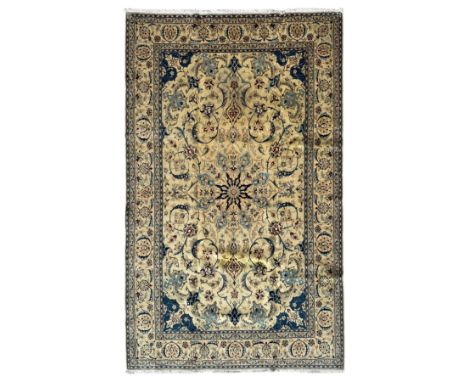 Nain Persian rug, hand knotted with a central medallion surrounded by a symmetrical arrangement of floral motifs, arabesques,