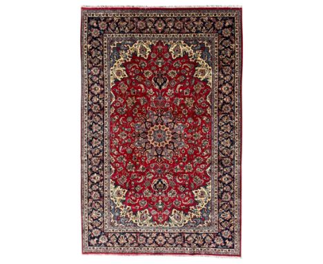 Najafabad Persian rug, hand-knotted, crimson red background with central field with a symmetrical  floral medallion surrounde