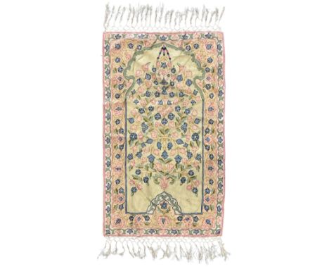 Small pastel prayer rug, cream field with Mihrab arch and trailing floral motifs in pink, blue, and green, bordered by floral