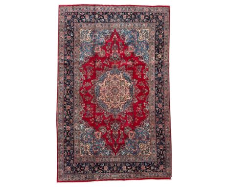 Meshed Persian rug, red, indigo, and teal background with repeating floral vine around a symmetrical floral medallion with bo