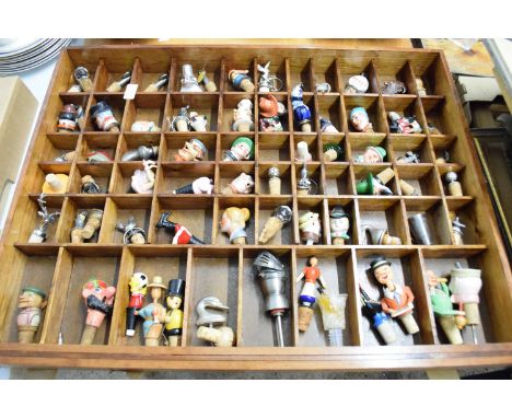 LARGE WOODEN DISPLAY CASE WITH QTY OF BOTTLE STOPPERS, SOME CERAMIC MODELS, FIGURAL HEADS, METAL ITEMS