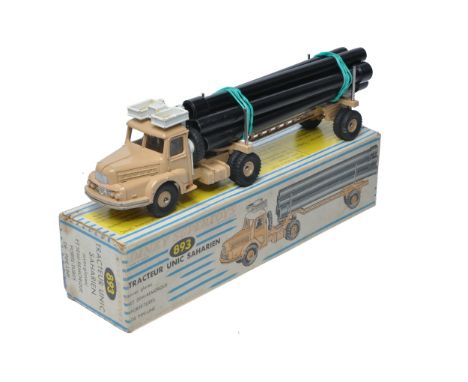 French Dinky No. 893 Unic Sahara Tractor with Pipe Trailer and Load. Displays good with some more notable marks. In good box,
