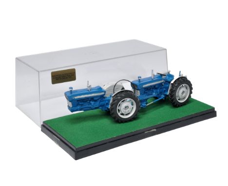 A well adapted Britains Farm 1/32 Model of a Doe 130 Tractor with custom wheels and parts as shown. With display case. 