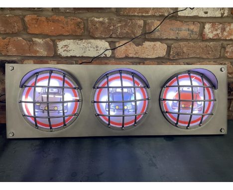 A MINI ILLUMINATED LIGHT BOX SIGN WITH THREE IMAGES IN SEPERATE HEADLIGHT DESIGN- WORKING ORDER AT TIME OF CATALOGUING  WIDTH
