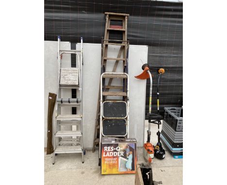 AN ASSORTMENT OF LADDERS TO INCLUDE A WOODEN STEP LADDER, TWO TUBULAR METAL STEP LADDERS AND A RES-Q-LADDER 