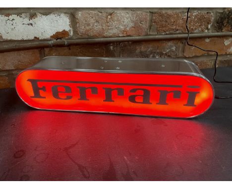 A FERRARI ILLUMINATED LIGHT BOX SIGN - WORKING ORDER AT TIME OF CATALOGUING.  WIDTH 44CM, HEIGHT 10.5CM, DEPTH 10CM 