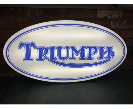 A TRIUMPH ILLUMINATED LIGHT BOX SIGN - WORKING ORDER AT TIME OF CATALOGUING.  WIDTH 94CM, HEIGHT 48CM, DEPTH 8CM 