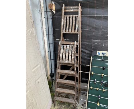 A VINTAGE WOODEN SIX RUNG STEP LADDER AND A FOUR RUNG WOODEN STEP LADDER 