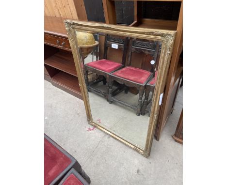 A MODERN GILT FRAMED WALL MIRROR, 40" X 28" 