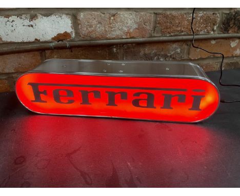 A FERRARI ILLUMINATED LIGHT BOX SIGN - WORKING ORDER AT TIME OF CATALOGUING.  WIDTH 44CM, HEIGHT 10.5CM, DEPTH 10CM 