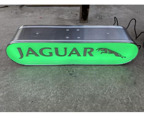 A JAGUAR ILLUMINATED LIGHT BOX SIGN - WORKING ORDER AT TIME OF CATALOGUING.  WIDTH 44CM, HEIGHT 10.5CM, DEPTH 10CM 