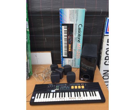 A CASIO CASIOTONE MT-220 KEYBOARD AND A LG SPEAKER SYSTEM 