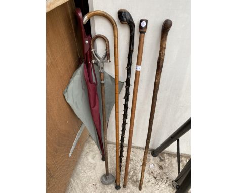 FOUR VARIOUS WALKING STICKS, ONE WITH A HALLMARKED SILVER HANDLE, A STICK SEAT AND AN UMBRELLA 