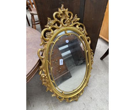 A MODERN OVAL GILT FRAMED WALL MIRROR, 29X18" 