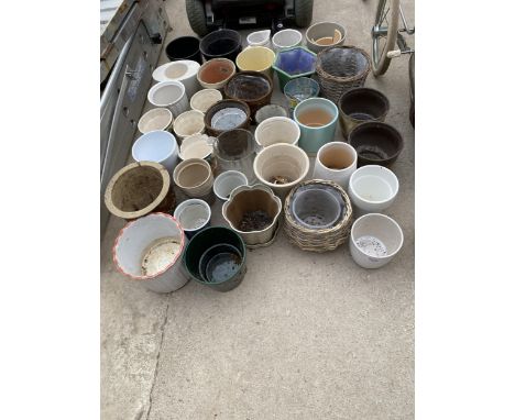 A LARGE QUANTITY OF CERAMIC AND WICKER PLANT POTS 
