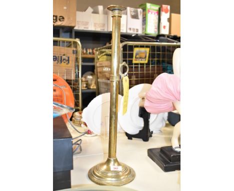 An unusual late 18th / early 19th century brass ejectors candlestick, having a long stem with pusher to the side, standing on