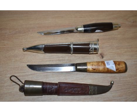 A late 19th century Norse Puukko hunting knife with tooled leather sheath, the steel blade decorated with calligraphy, mounte