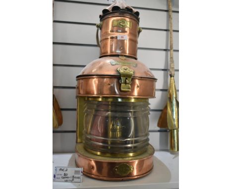 A large early 20th century copper and brass Masthead navigation ship lantern, having a bow-fronted form with fresnel lens gla