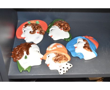 A group of mid-century Moorland Staffordshire pottery portrait plaques in the Art Deco style, hand coloured in vibrant orange