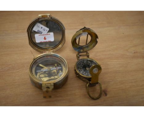 An early 20th century brass military type compass, marked to top 'Stanley London', w7cm, sold alongside another compass, w5cm
