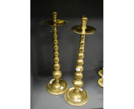 A tall pair of mid-century bobbin stem brass candlesticks, h53cm