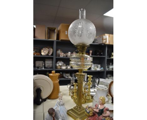 A large quality early 20th century brass Corinthian column oil lamp, having a globular etched glass shade, duplex burners and