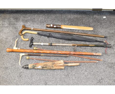 A box containing various walking sticks, to include a swagger stick and Chinese umbrella, (8).