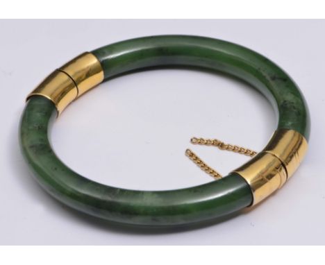 A CHINESE SPINACH GREEN JADE BANGLE with gold hinge and clasp, 19th Century