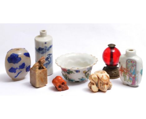 A SMALL GROUP to include a famille rose tea bowl, three snuff bottles, a Mandarin hat finial, a netsuke, a soapstone seal and