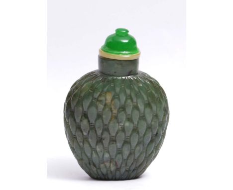 A CHINESE DARK GREEN JADE OVIFORM SNUFF BOTTLE carved with an allover rice grain pattern, green glass and mother of pearl sto
